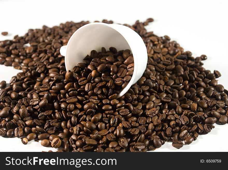White cup with coffee beans (on white background)
