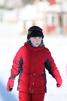 Cute Boy In Red Snowsuit And Rosy Cheeks Stock Photography