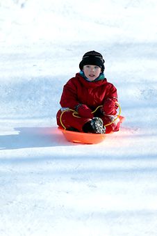 Boy In Red In Sled Going Downhill Royalty Free Stock Photography Boy In Red In Sled Going Downhill Royalty Free Stock Photography