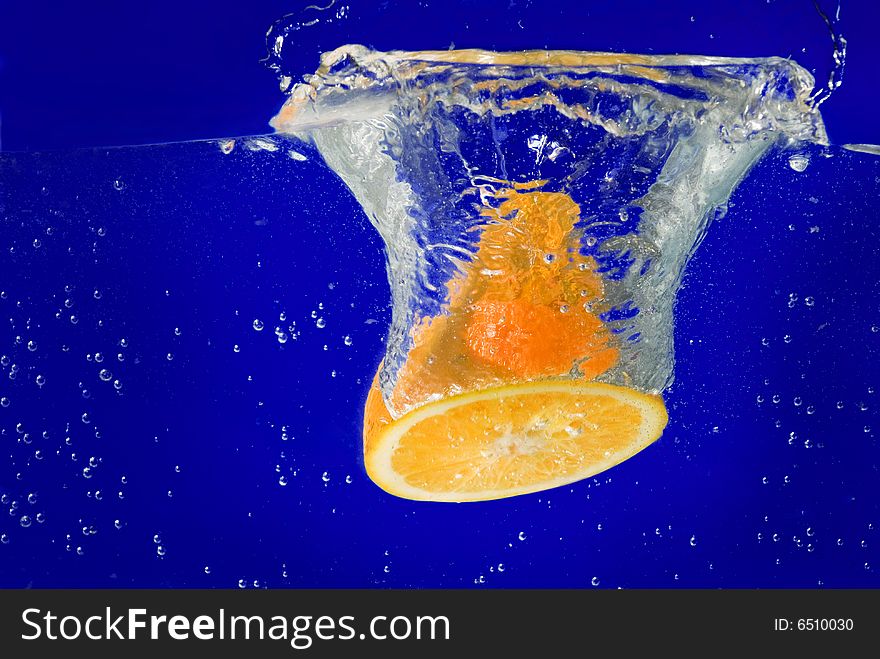 A fresh orange under water. A fresh orange under water