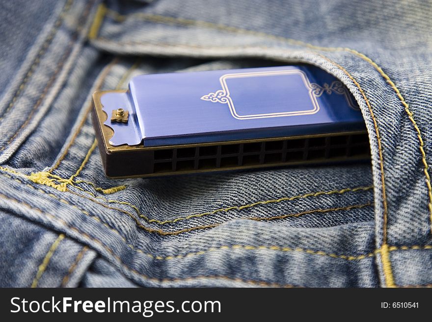 Blue harmonica in blue jeans pocket