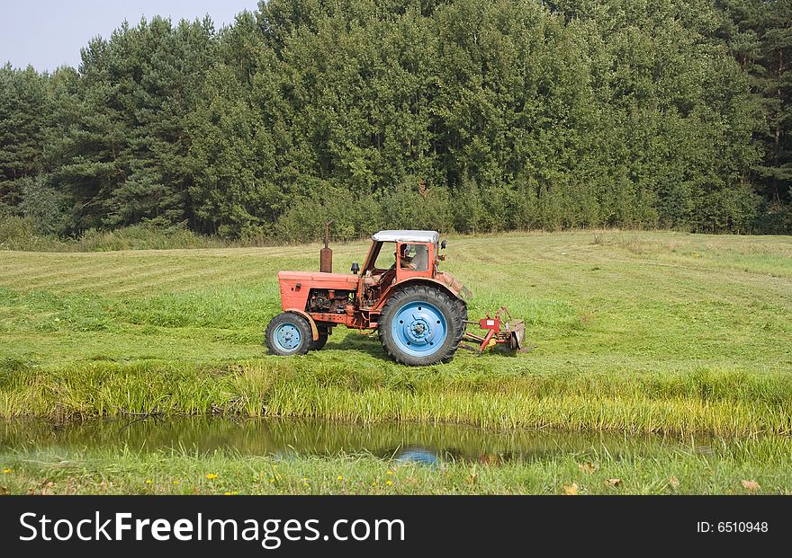 Tractor harvest, green landscape, Lithuania
