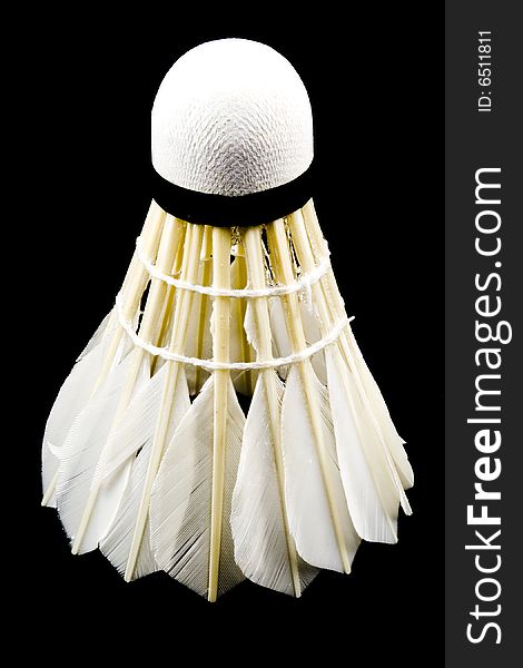 A white shuttlecock with feathers on the black background