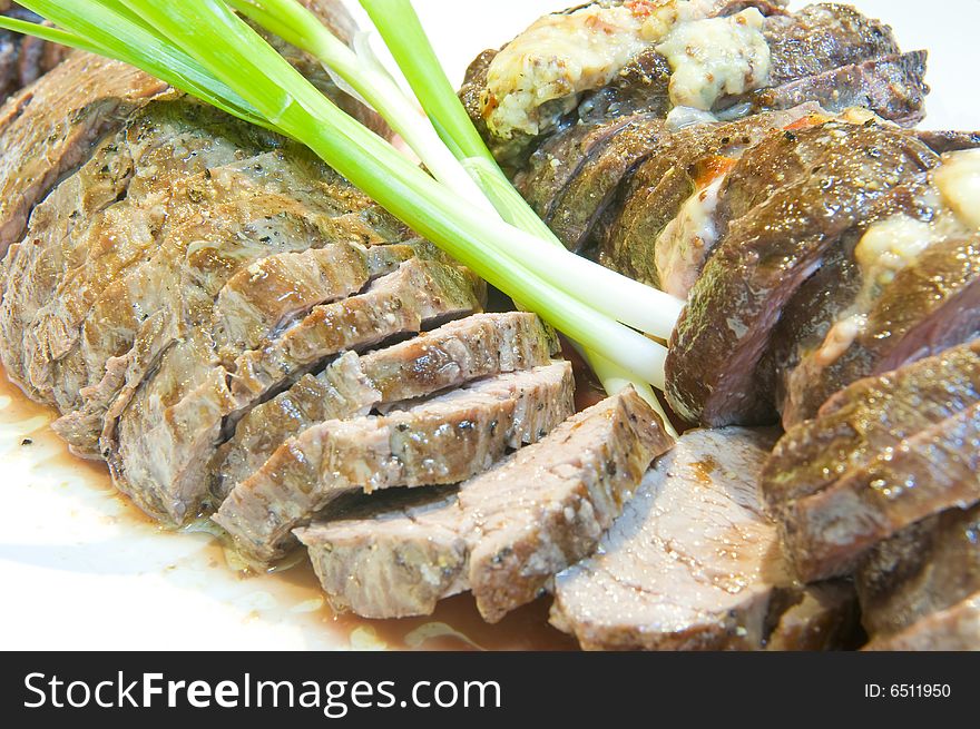 Delicious sliced fillet steak of a Kudu, medium done and served on a plate.