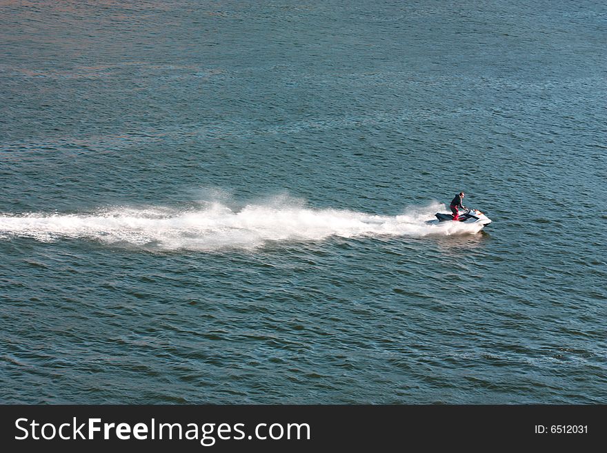 Man is driving a water-bike. Man is driving a water-bike