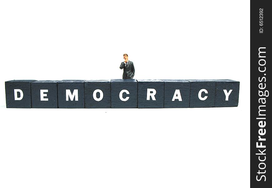 A man standing behind the word democracy