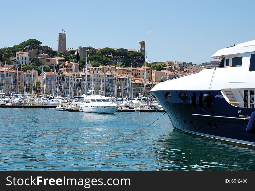 Scenic view of yachts moored in Cannes marina with boat in foreground, France.