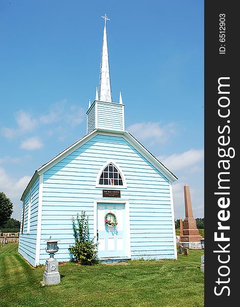 An blue wooden church.