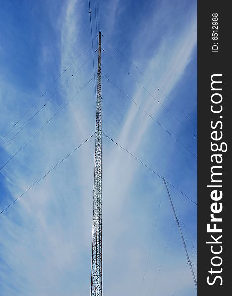 Wide angel shot of a radio tower from below in the blue sky. Wide angel shot of a radio tower from below in the blue sky.