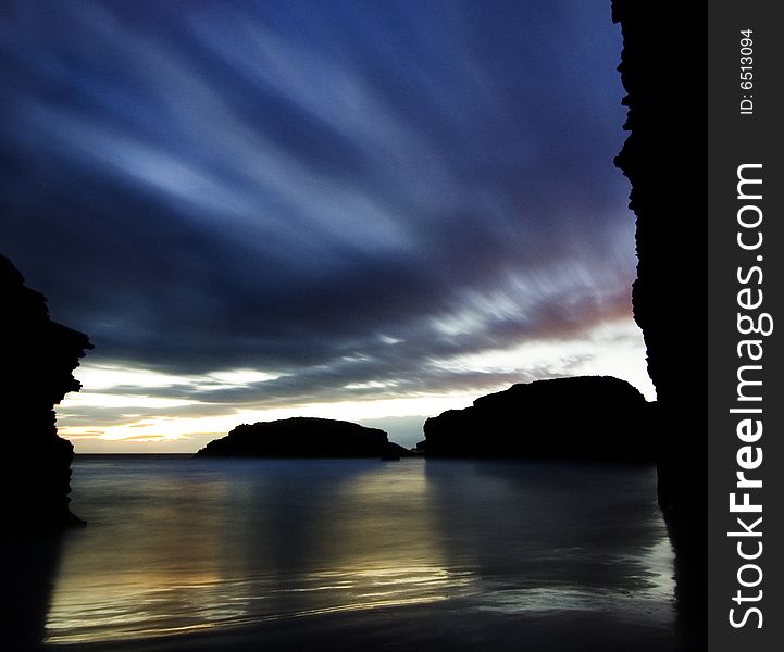 A blue and golden sunrise at the beach. A blue and golden sunrise at the beach