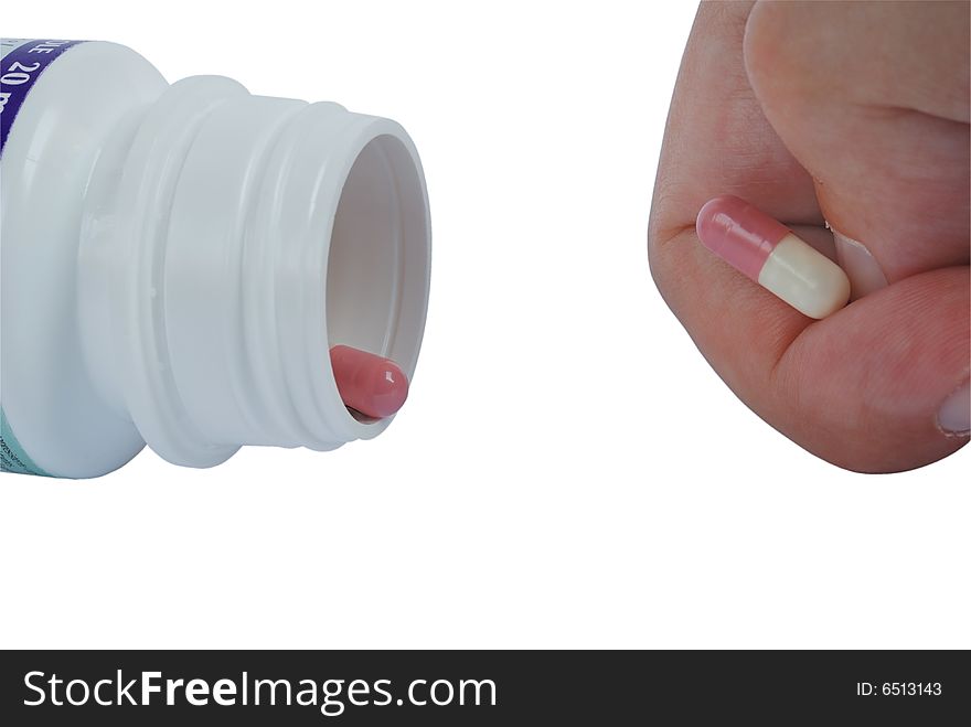Closeup of a hand playing with a pill isolated on white with clipping path. Closeup of a hand playing with a pill isolated on white with clipping path