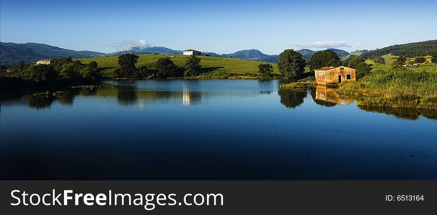 A lonely ruin house near a quiet lake. A lonely ruin house near a quiet lake