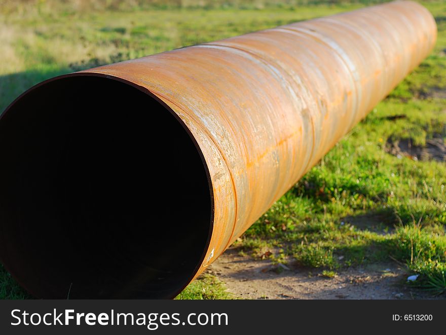 Steel pipe on green grass