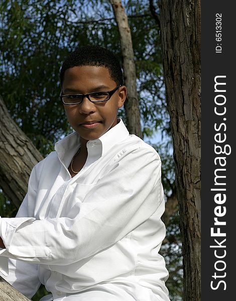 Attractive young African American teenager in a white shirt outside. Attractive young African American teenager in a white shirt outside