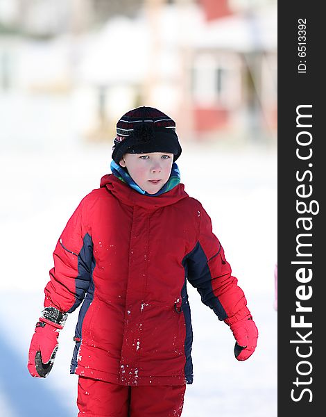 Cute Boy In Red Snowsuit And Rosy Cheeks