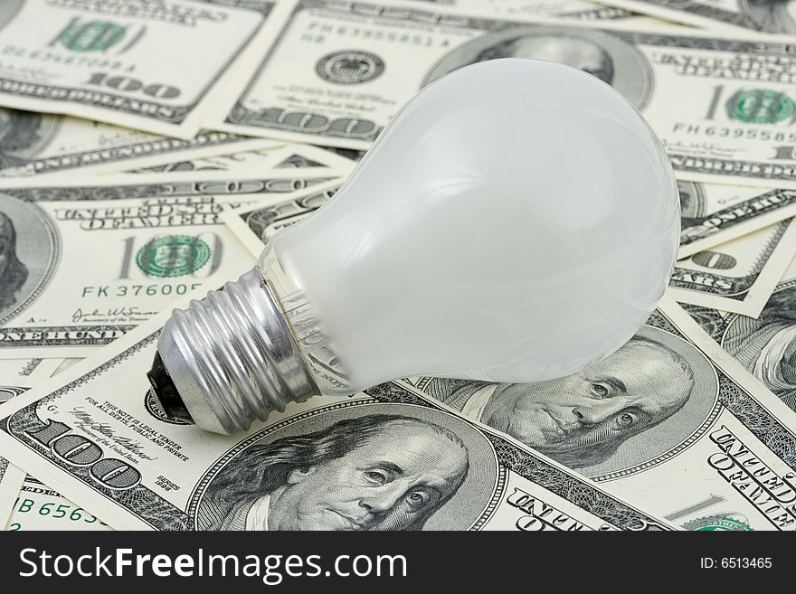 Lamp on money background, business concept