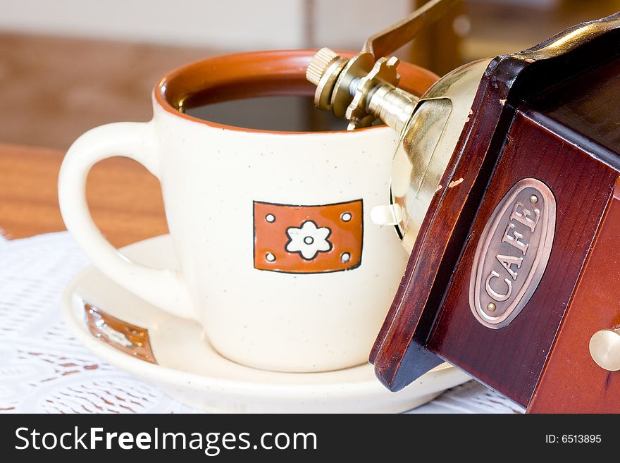 A coffee-mill on a table. A coffee-mill on a table