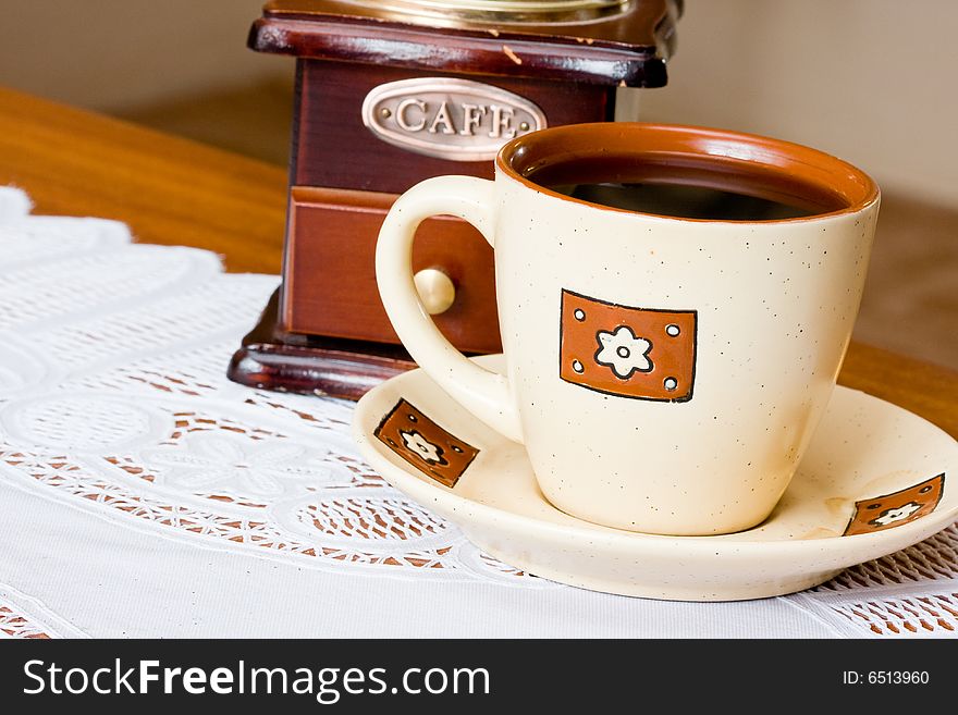 A coffee-mill on a table. A coffee-mill on a table