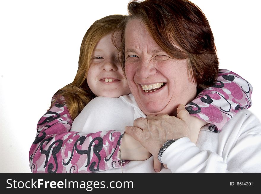 Grandmother and granddaughter cuddling eachother