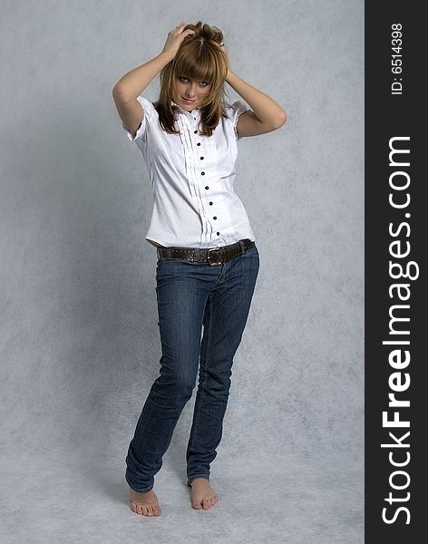 Stylish girl in white blouse and blue jeans