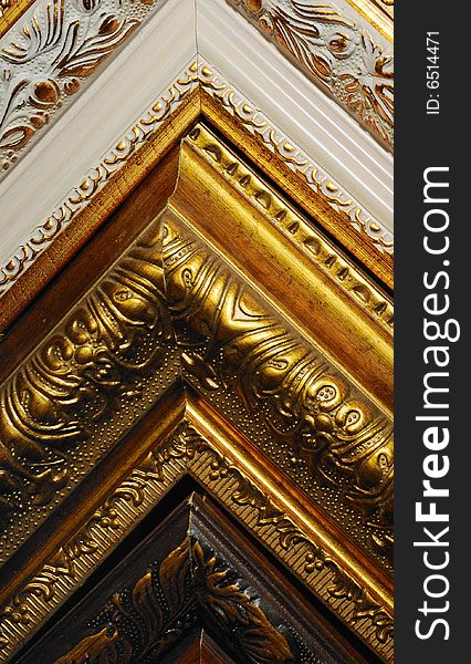 Ornate wooden corners of frame
