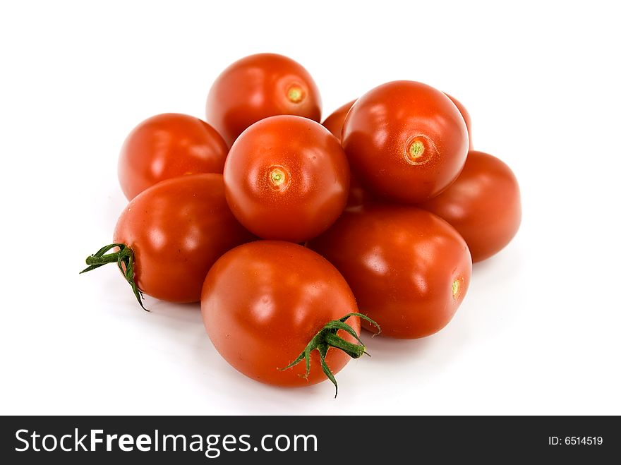 Many tomatoes on the vine .