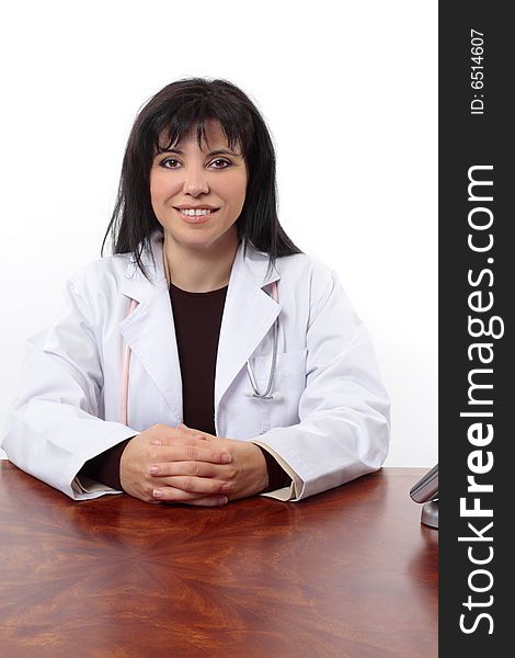 Smiling doctor sitting at desk