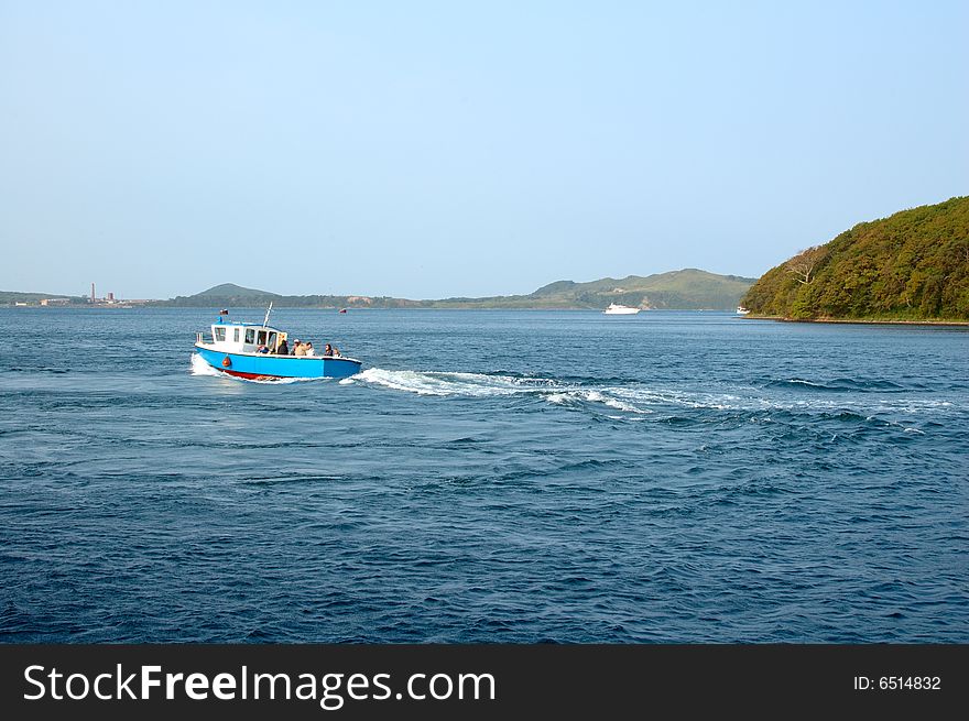 Sea scenery with blue motor-boat. Sea scenery with blue motor-boat.