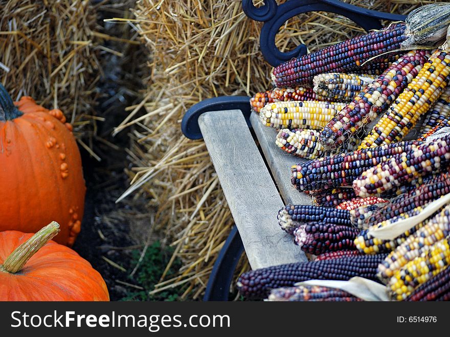 Indian corn and pumpkins by hay bales. Indian corn and pumpkins by hay bales.