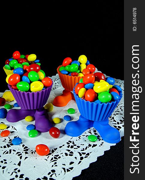 Bright party cups filled with colorful candy. Bright party cups filled with colorful candy.