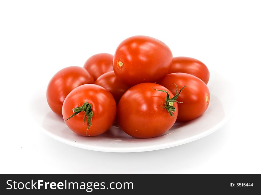 Many tomatoes on the vine .