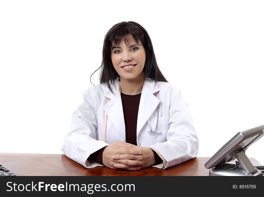 Friendly doctor confidently sits at her desk. Friendly doctor confidently sits at her desk
