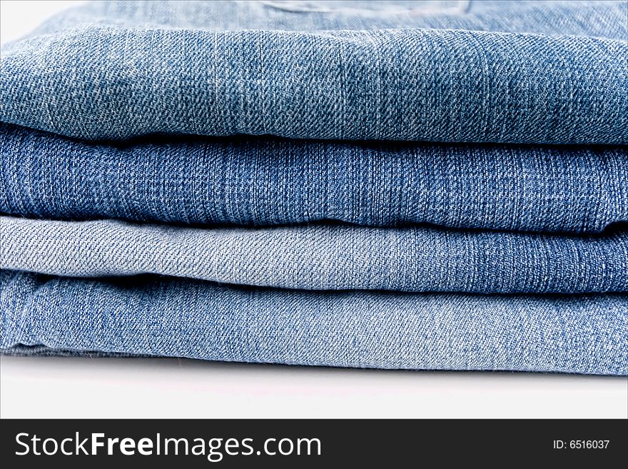 A pile of jeans in shades of blue