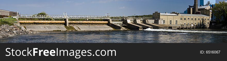 Panorama of a Mississippi River dam with an adjoining 100 year old paper mill in St. Cloud, Minnesota, USA. Panorama of a Mississippi River dam with an adjoining 100 year old paper mill in St. Cloud, Minnesota, USA