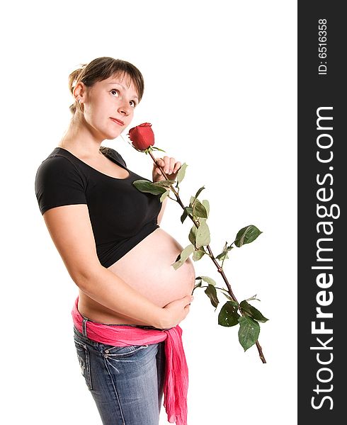 Beautiful pregnant woman with a rose isolated against white background