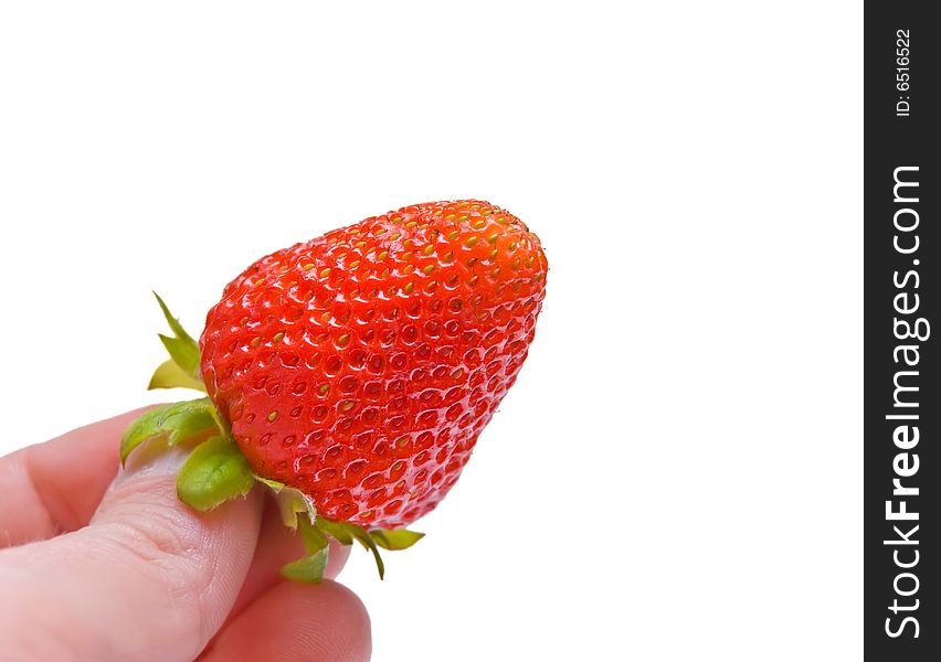 Hand holding a fresh strawberry