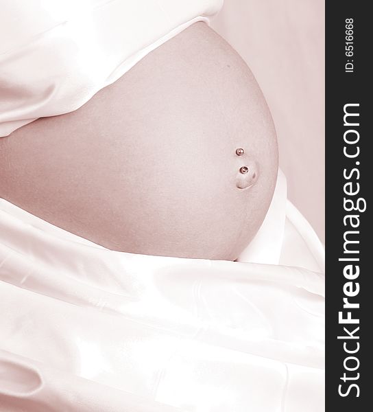 Womens pregant belly with white cloth around her belly. Womens pregant belly with white cloth around her belly