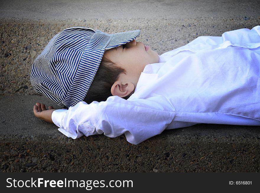 A small boy a sleep on a stairwell. A small boy a sleep on a stairwell