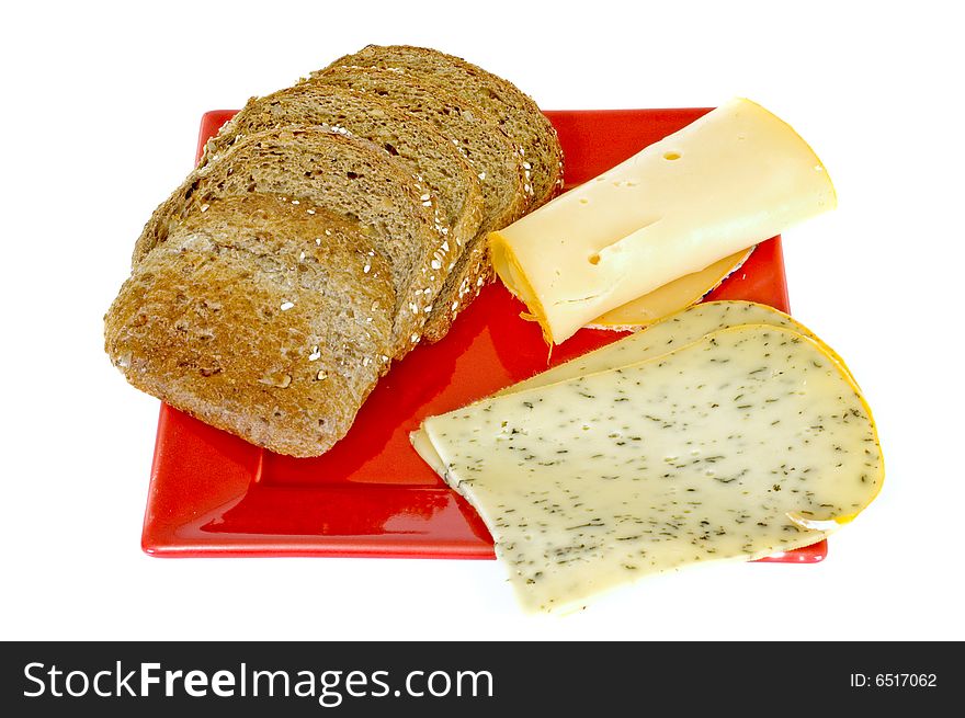 Bread and cheese on red platter, white background