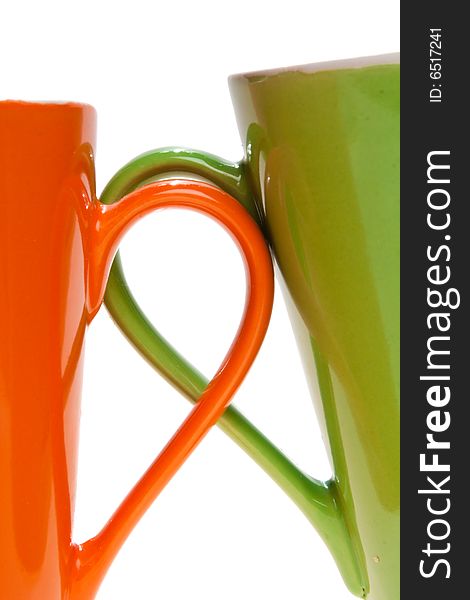 Orange and green tea cup handles, isolated