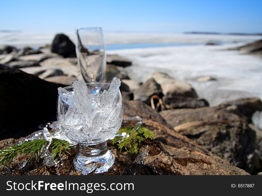 Glasses with ice on the edge of a frozen lake