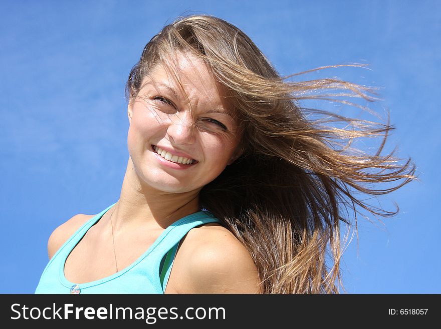 The young girl on a background of the dark blue sky