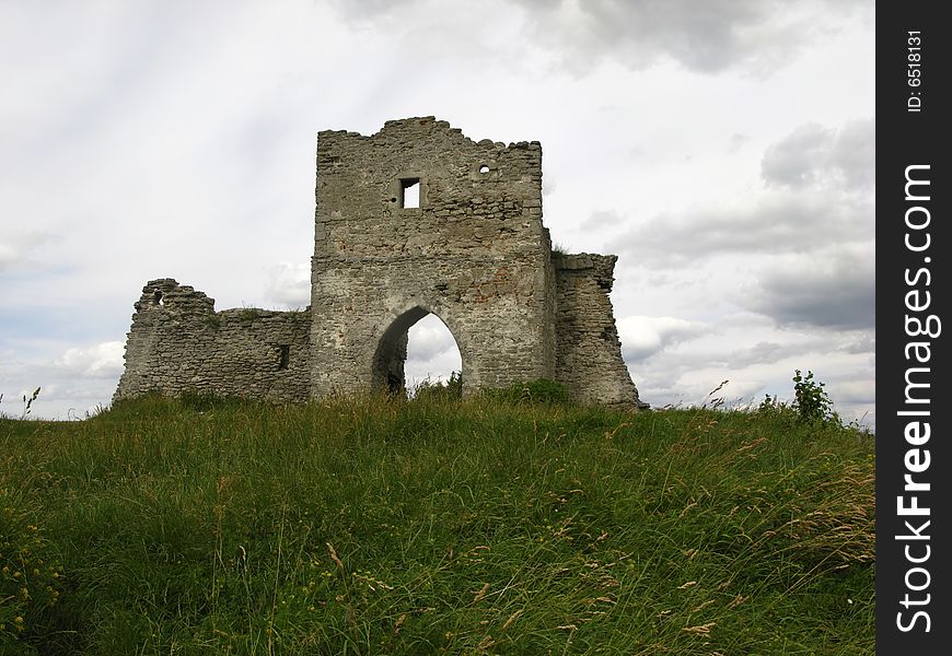 Green herb and ruins of an old fortress