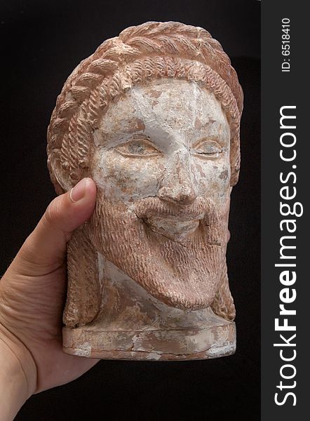 Ancient Greek Statue Of A God In Hand Isolated