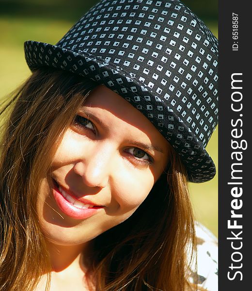A beautiful girl with a hat enjoying the sunny weather