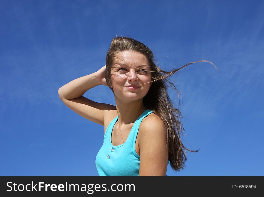 The young girl on a background of the dark blue sky