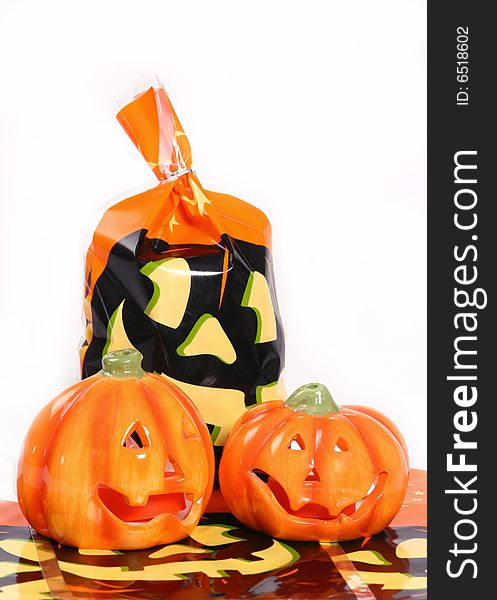 Halloween treat bag with two ceramic pumpkins on an isolated white background. Halloween treat bag with two ceramic pumpkins on an isolated white background