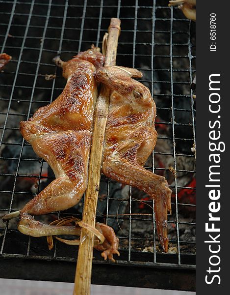 Chicken is grilled on a grill at a restaurant. Chicken is grilled on a grill at a restaurant.