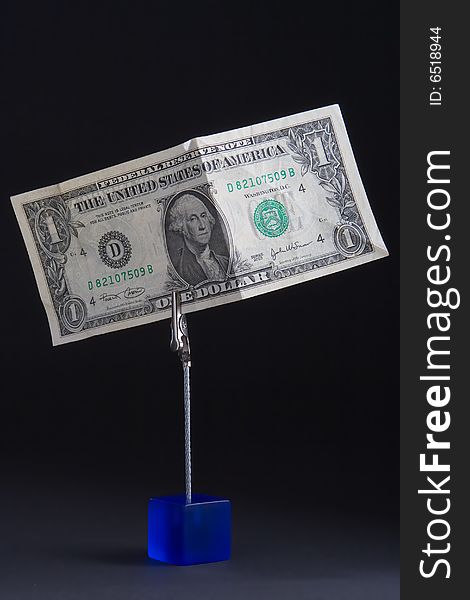 American banknote on a clothespin on a black background. American banknote on a clothespin on a black background