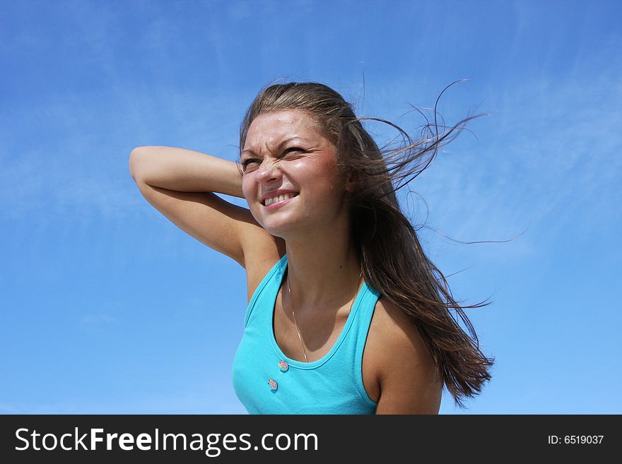 The young girl on a background of the dark blue sky